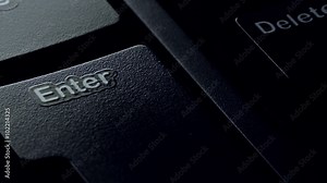 Pressing the enter key on a computer keyboard. close-up