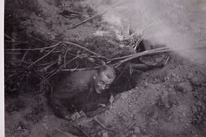 American WW II officer Curtis Strand of the 9th USAAF in his foxhole before the "breakout at Saint Lô, France."