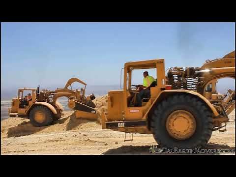 CAT 631D Scrapers being push loaded by D9 Dozers