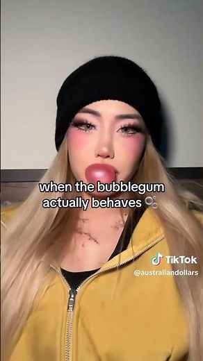 beautiful girl blowing bubble gum bubbles