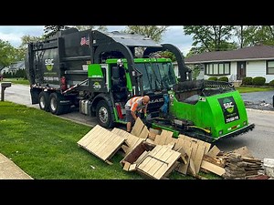 SBC Waste Front Loader Garbage Trucks Packing Bulk at the Spring Cleanup