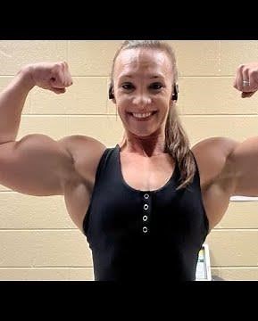 Beautiful muscular woman showing off her muscles