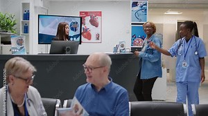 Young adult paying checkup consultation with credit card at clinical reception counter desk, having medical appointment with specialist. Patient talking to receptionist in facility lobby.