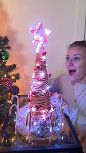 Our friend made her famous Candy Cane Tree 🎄 Our friend Nicole shows us how to make an amazing candy cane Christmas tree by heating up candy canes so she can bend them around a cone. Then she dresses it with star mints, LED lights, and even molds a star mint star with a cookie cutter. Great last minute idea for holiday decorating for parties and gatherings. #christmasdecor #christmascrafts #holidaydecorideas #candycane #christmas2025 | The Tus House