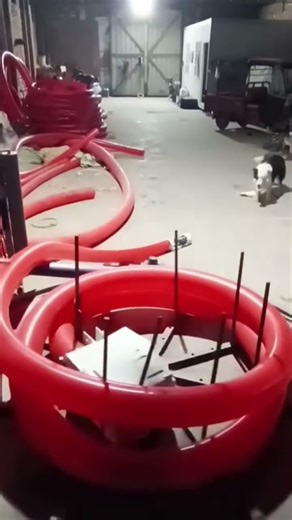 RED Plastic Pipe Rolling in Metal Frame