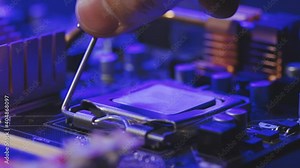 Installing a computer processor CPU. A technician connects a microprocessor to a motherboard. Replacing a computer processor CPU