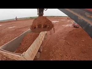 Excavator TRUCK LOADS MATERIAL WITH STONES