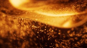 Abstract Golden Shimmering Liquid Dynamic Particles Background