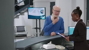 Female Receptionist Talking Man Medical Neck Collar Being Pain Having