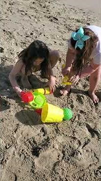 Kids are playing on the beach with sand and having lots of fun. 1st beach day of 2023