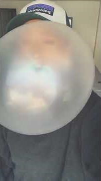 Woman blowing huge bubblegum bubbles