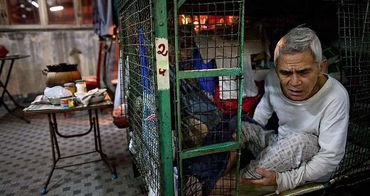 21 Harrowing Images Of Life Inside Hong Kong's Tiny Cage Homes