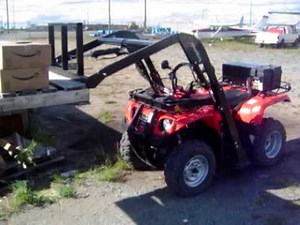 GroundHog loader with Forks attachment on ATV/Quad