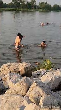 Children swimming in lake