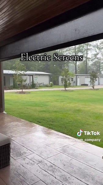 Back porch goals for your dream Barndominium 😍 Large glass sliding doors, a fully decked-out outdoor kitchen, electric screens, stamped colored concrete, a tongue-and-groove ceiling with built-in speakers, plus a double-sided fireplace to enjoy those perfect sunset views. What more could you ask for? I hope you have been Barndo Inspired.® #TheBarndominiumCompany #Barndominium #BackPorchInspiration #BarndoLife #OutdoorLivingSpace