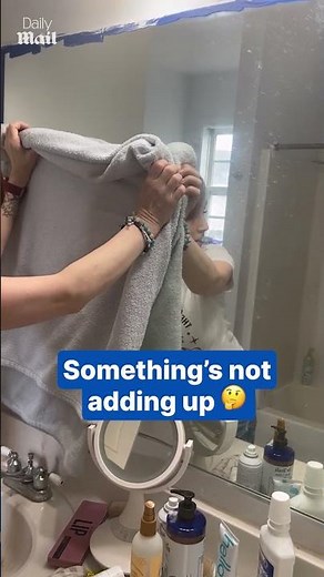 Woman stunned as reflection appears in covered mirror