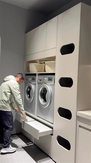 The washer and dryer are elevated for easier access, supported by a pull-out platform that improves loading efficiency and maintains a clean, integrated look🧺💡✨ • • #LaundryroomDesign #laundrycabinet | Tiffany Design Studio