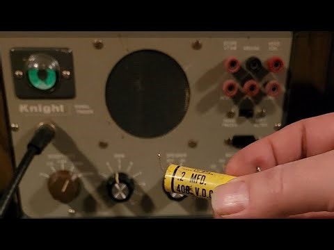 Signal tracer testing the outside foil end of capacitors.