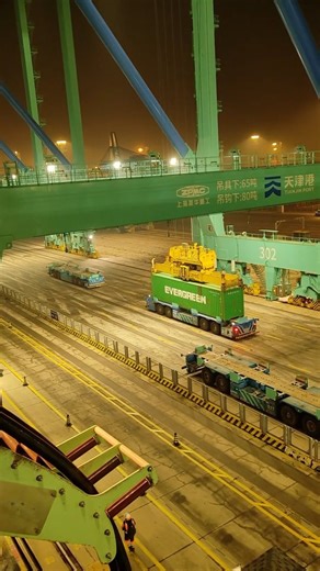 Wander Joy on Instagram: "The Synergy of Automation and Sustainability at Tianjin Port. This is what the future of global trade looks like in 2026. This shot from Tianjin Port captures the "Smart Port" ecosystem in full swing: Autonomous transport vehicles (IGVs) moving containers with millimetric precision, orchestrated by a sophisticated AI "brain" that optimizes every route in real-time. Underpinned by 5G-Advanced (5.5G) connectivity, these operations occur with ultra-low latency, ensuring se