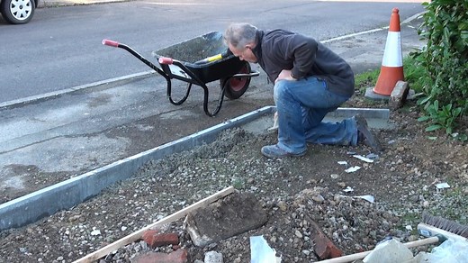 Laying concrete edging stones to driveway