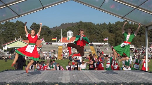 Competitors in the Irish Jig Highland dancing heats, held during the 2024 Braemar Gathering in Scotland on Saturday 7th September 2024. This was at the end of the Games as people were leaving. The Irish Jig is one of the Scottish National Dances for competitions and intended as a parody of the infamous Irish temper; an energetic dance featuring lots of fist shaking and skirt flouncing among female competitors. It is one of the two Scottish National dances that has its own costume, rather than th