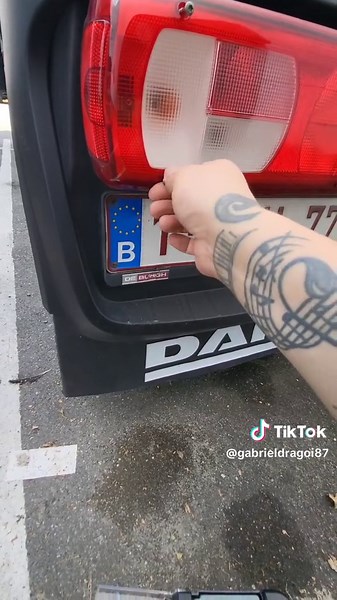 Removing a License Plate: Red and Black Tools in Action