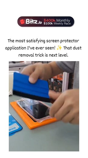 universal mems on Instagram: "The post features a 26-second video demonstrating a Spigen EZ Fit screen protector installation on an iPhone, using a roller tape to magnetically attract and remove dust for a bubble-free application, described as highly satisfying. Uploaded on 8 December 2025 by influencer , it has garnered 1.7 million views and 2,000 likes within four days, indicating rapid virality among gadget enthusiasts. Replies largely consist of Amazon affiliate links to the £15.99 kit, alig