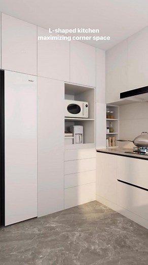 an L-shaped kitchen maximizing corner space with floor-to-ceiling cabinets💡💫✨ The design incorporates a large, built-in black refrigerator and a dedicated open shelf for a microwave and other small appliances. | Tiffany Design Studio