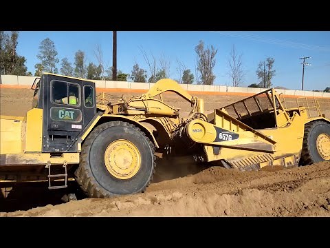 CAT 657G and 651B scrapers moving dirt - D9T Dozer ripping and pushing
