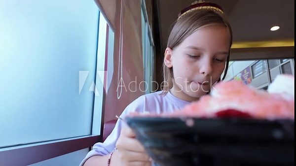 Preteen Girl Eating Huge Signature Ice Cream Dessert at Cafe