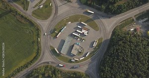 Aerial high drone in 4K flight over evening road traffic in Kiev, Ukraine. Highway and overpass with cars and trucks, interchange, two-level road junction in the big city. Top view.