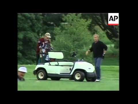 Bush plays golf with dad on Father's Day, comments on Middle East