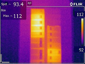 What causes a hot circuit breaker in an electrical panel?