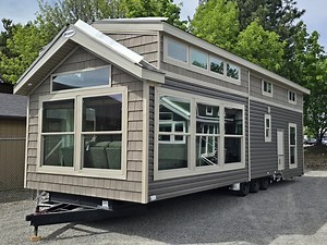 Today we are touring the Kropf Island 4809AK. This model has been known for its beautiful window packages to capture all that natural light to make it feel more open and airier inside. This model comes with more storage than you will see in most park models on the market which is a huge plus! This model is also a split loft which mean you will have two full separate loft areas for sleeping or storage. For more info on this house or others that we offer. Please call us at 888-222-2699 and we woul