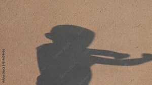 shadow of child is having fun. Blur shadows of child on wall. Game with light and shadow. Shadow play