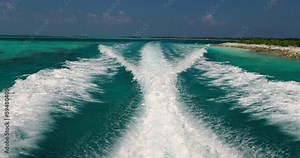 Ship's wake. The view from the boat is moving. A wide wake from a boat. Rear view. Ocean water. Dark blue. Trace from the ship.