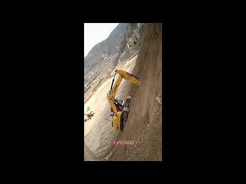Excavator climbing steep dirt hill
