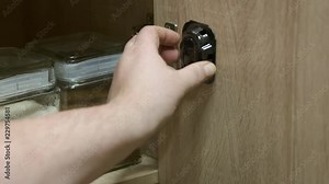 Using cockroach killing baits and sticky traps to kill roaches in the kitchen. Placing plastic bait stations. Cockroaches stuck on sticky cockroaches trap. Sequence.