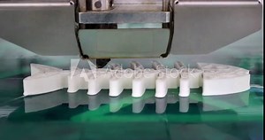 3D printer working and creating an object from the hot molten plastic